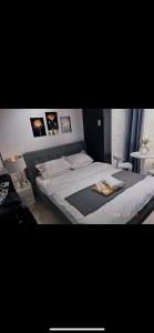 a bedroom with a large white bed with pictures on the wall at A&R Haven in Manila +6 photos