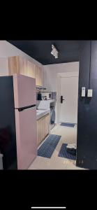a kitchen with a white refrigerator and a stove at A&R Haven in Manila