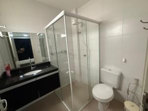 a bathroom with a shower and a toilet and a sink at Fitroom Apartment in Santarém