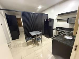 a small kitchen with a table and a small table and a tableablish at Fitroom Apartment in Santarém +3 photos