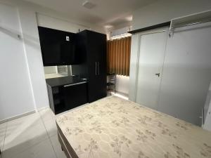 a bedroom with a bed and a television in it at Fitroom Apartment in Santarém