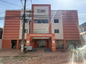 a red and white building with a front entrance at Fitroom Apartment in Santarém