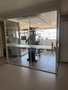 a large glass window in a room with a gym at Fitroom Apartment in Santarém