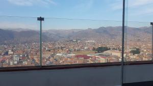 a view of a city from a window at La Estancia del Abuelo in Cusco