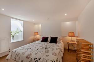 a bedroom with a large bed and two lamps at 4 Bed in Walmer oc-c29264 in Deal