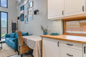 a kitchen with a table and a blue couch at Stark House Gallery in Borsk