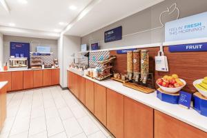 a grocery store aisle with fruits and vegetables on display at Holiday Inn Express Hotel & Suites Lonoke I-40 by IHG in Lonoke