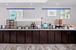 a kitchen with a counter top with some food at Garner Hotel Mazatlan Beach by IHG in Mazatlán