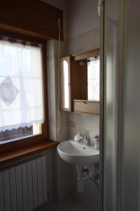 a bathroom with a sink and a window at Fabbricato Indipendente Centro in Lozzo Cadore +24 photos