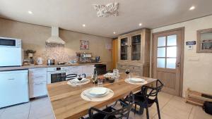 a large kitchen with a wooden table and chairs at Refuge des Sottais in Burg-Reuland