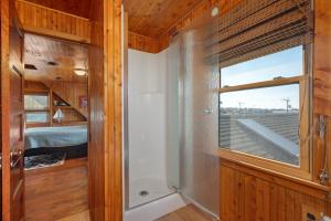 a bathroom with a window and a bed in a room at NH330 It's Beach Time in Nags Head +53 photos