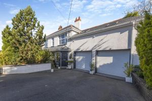 a large white house with a garage at 2 Bed in Horns Cross oc-l29271 in Bucks Mills