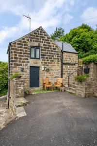 a stone house with a table and two benches at 1 Bed in Ashover oc-dclhil in Ashover