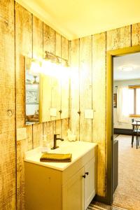 a bathroom with a sink and a mirror at Charming Ski Chalet at Powderhorn Mountain in Bessemer