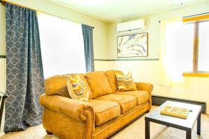 a living room with a brown couch and a table at Charming Ski Chalet at Powderhorn Mountain in Bessemer +20 photos