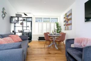 a living room with a couch and a table at Modern Town House Bangor City Centre in Bangor