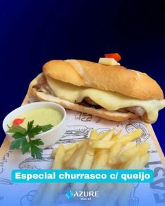 a sandwich and french fries and a bowl of sauce at Azure Motel (adults only) in Registro