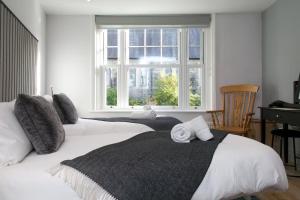 a bedroom with two beds and a window at Modern Town House Bangor City Centre in Bangor