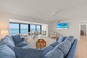 a blue couch in a living room with the ocean at Mariner Pointe 941 in Sanibel