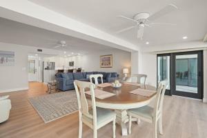 a dining room and living room with a table and chairs at Mariner Pointe 941 in Sanibel