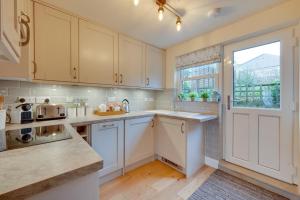 a kitchen with white cabinets and a window at 1 Bed in Crakehall oc-ds955 in Crakehall
