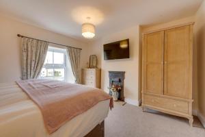 a bedroom with a bed and a dresser and a window at 1 Bed in Crakehall oc-ds955 in Crakehall