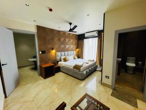 a hotel room with a bed and a bathroom at Mannat Hotel in Tezpur