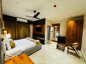 a bedroom with a bed and a television in a room at Mannat Hotel in Tezpur