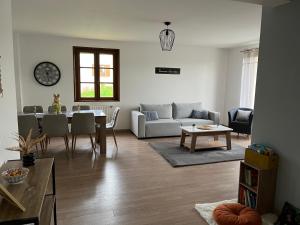 a living room with a couch and a table at Escapade in Soulaines-Dhuys