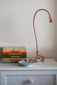 a lamp sitting on top of a table with books at Spitaki by the Sea in Paralimni