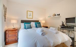 a bedroom with a large white bed with towels on it at 1 Bed in Belford oc-nb677 in Belford