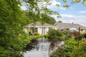 a house with a pond in front of it at 1 Bed in Belford oc-nb677 in Belford