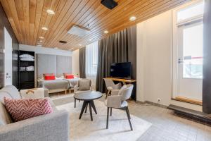 a living room with a couch and a table at Santa's Hotel Santa Claus in Rovaniemi +79 photos
