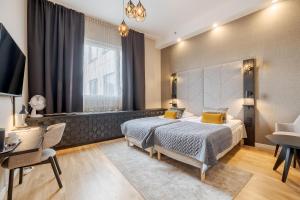 a bedroom with a bed and a desk and a window at Santa's Hotel Santa Claus in Rovaniemi