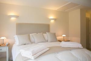 a bedroom with a white bed with towels on it at 3 Bed in Low Row oc-ds1030 in Gunnerside