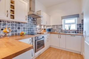 a kitchen with white cabinets and a window at 3 Bed in Bainbridge oc-ds1026 in Bainbridge