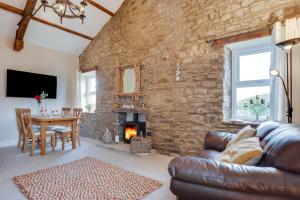 a living room with a stone wall at 3 Bed in Bainbridge oc-ds1026 in Bainbridge