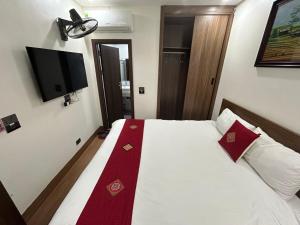 a bedroom with a bed with a red ribbon on it at OnTop Hotel in Sapa