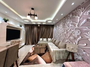 a living room with a couch and a tv at Paradise view at Sharm Hills in Sharm El Sheikh