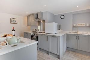 a kitchen with white cabinets and white counter tops at 1 Bed in Gunnerside oc-ds1016 in Gunnerside