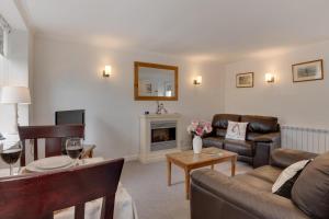 a living room with a couch and a fireplace at 1 Bed in Gunnerside oc-ds1016 in Gunnerside
