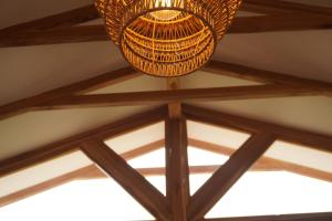 a chandelier hanging from the ceiling of a building at Hermosa casita frente al mar en San Jose - Olon in San José +23 photos