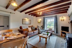 a living room with a couch and a table at 2 Bed in Low Row oc-ds059 in Feetham