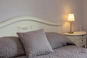 a bed with a pillow and a lamp on a table at 2 Bed in Low Row oc-ds059 in Feetham