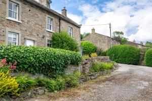 an old brick house with a garden in front of it at 2 Bed in Low Row oc-ds059 in Feetham