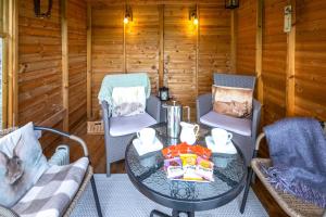 a room with a table and chairs in a cabin at 2 Bed in Low Row oc-ds059 in Feetham +22 photos