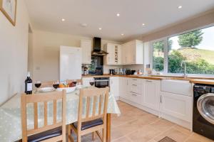 a kitchen with white cabinets and a table and chairs at 2 Bed in Hawes oc-ds052 in Hawes