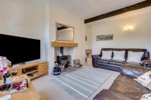 a living room with a couch and a flat screen tv at 2 Bed in Hawes oc-ds052 in Hawes