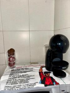 a table with a coffee maker with a sign on it at Appartement Bissau in Dakar
