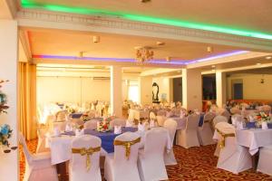 a large banquet hall with white tables and chairs at Sunset Araliya by Diyakawa in Aluthgama